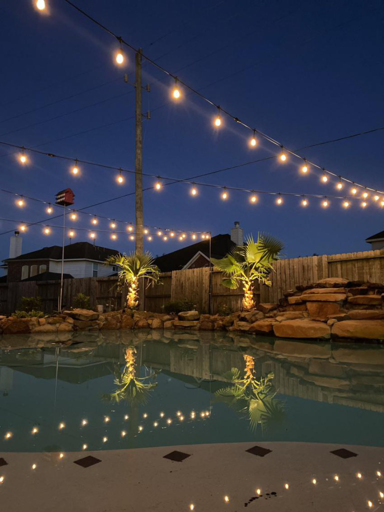 string lights hanging over the pool