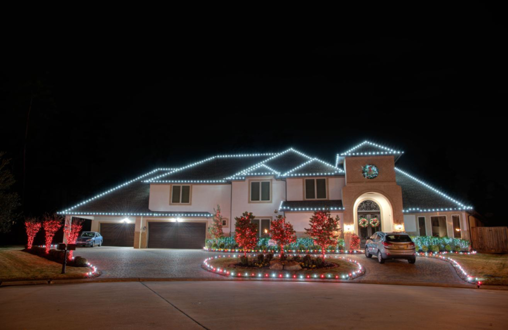 A house decorated with red and white string lights, possibly for Christmas.