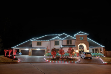 A house decorated with red and white string lights, possibly for Christmas.