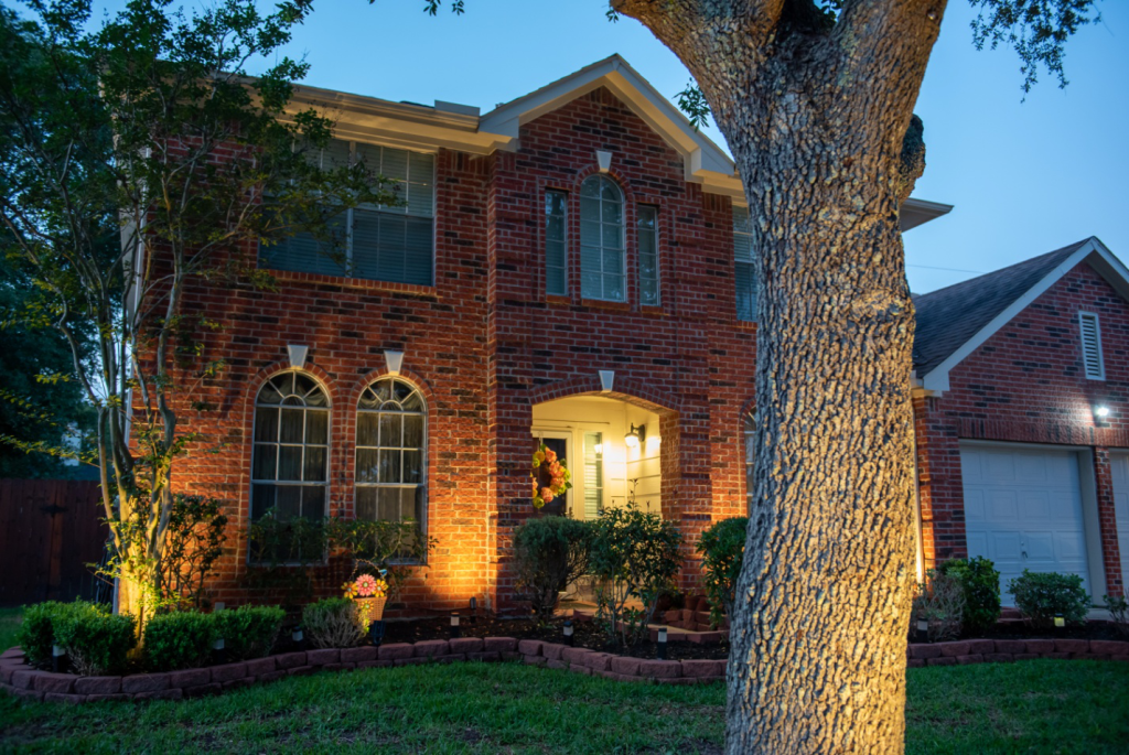 A house bathed in beautiful exterior lighting.