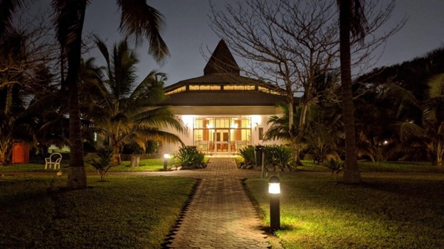 A house lit up at night with permanent lights