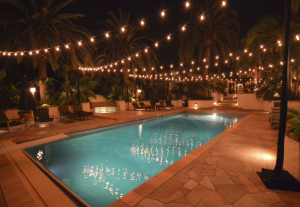 Bistro lights hanging over a pool